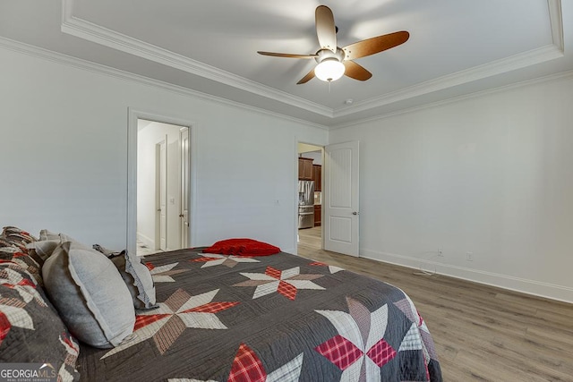 bedroom featuring crown molding, ceiling fan, baseboards, and light wood-style floors