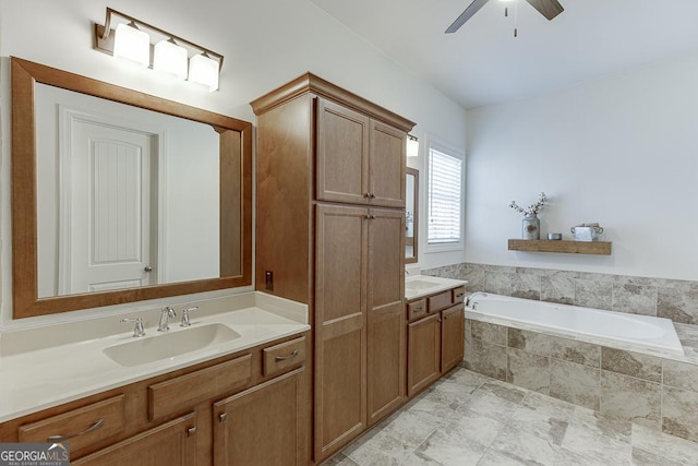 full bathroom featuring a ceiling fan, a garden tub, and vanity