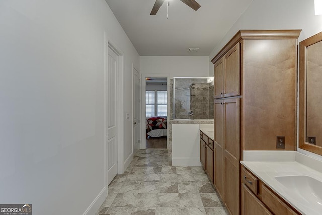 full bathroom featuring ensuite bathroom, ceiling fan, a tile shower, and vanity