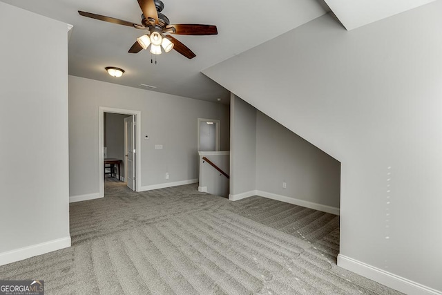 interior space with carpet floors, baseboards, and a ceiling fan