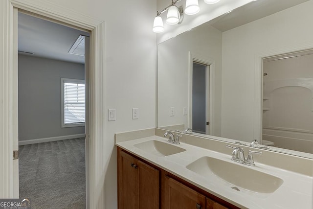 full bathroom with double vanity, a sink, visible vents, and baseboards