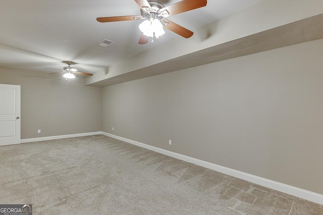 empty room with carpet floors, baseboards, and visible vents