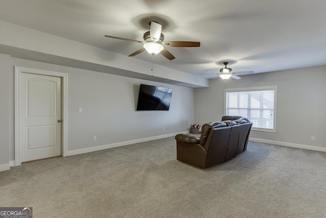 living room featuring ceiling fan, carpet, and baseboards