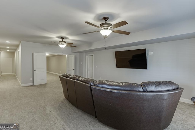 living room featuring light carpet, ceiling fan, and baseboards