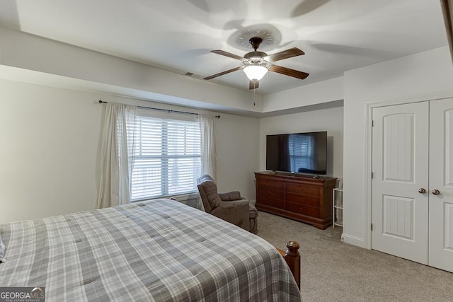 bedroom featuring ceiling fan, a closet, carpet, and visible vents