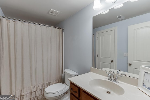 bathroom with a shower with shower curtain, visible vents, vanity, and toilet