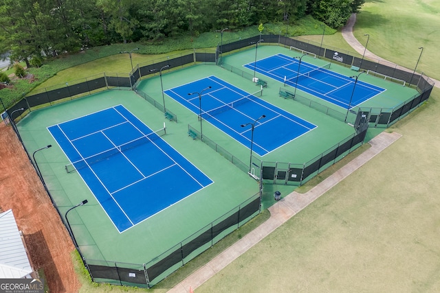 view of tennis court featuring fence