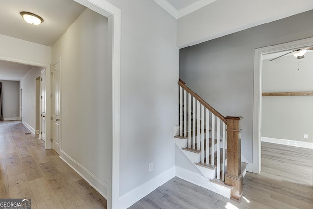 staircase with baseboards and wood finished floors