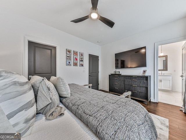 bedroom featuring ceiling fan, connected bathroom, and hardwood / wood-style floors