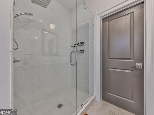 bathroom featuring tile patterned floors and a shower with shower door