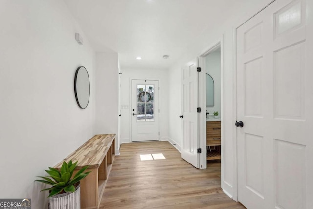 corridor with light hardwood / wood-style floors