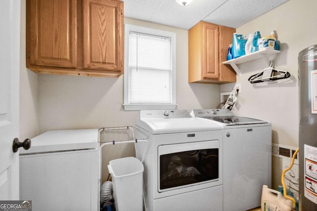 clothes washing area with cabinets and independent washer and dryer