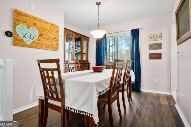 dining room with dark hardwood / wood-style flooring