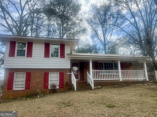 split level home with a porch and brick siding