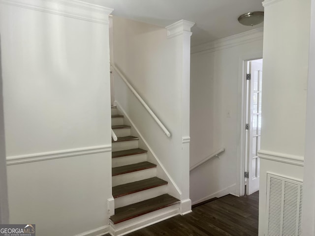 staircase featuring ornate columns, ornamental molding, and wood-type flooring