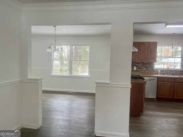 kitchen featuring sink, hanging light fixtures, stainless steel dishwasher, ornamental molding, and backsplash