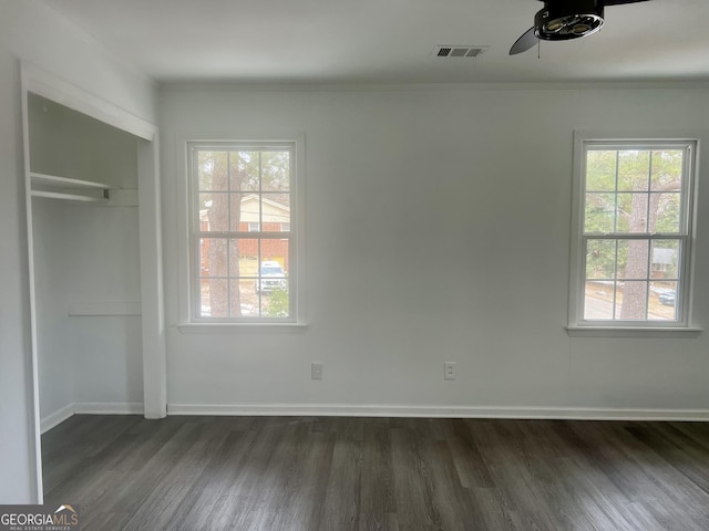 interior space with dark hardwood / wood-style flooring, ornamental molding, a closet, and ceiling fan