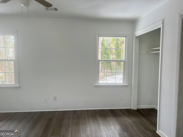 831 Bel Air Cir, Griffin, GA 30224 - unfurnished bedroom featuring visible vents, dark wood-style flooring, crown molding, and a closet