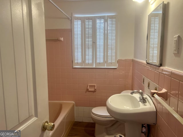 831 Bel Air Cir, Griffin, GA 30224 - bathroom with tile walls, wainscoting, and toilet