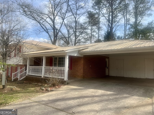 831 Bel Air Cir, Griffin, GA 30224 - view of front of house featuring a porch, aphalt driveway, and brick siding