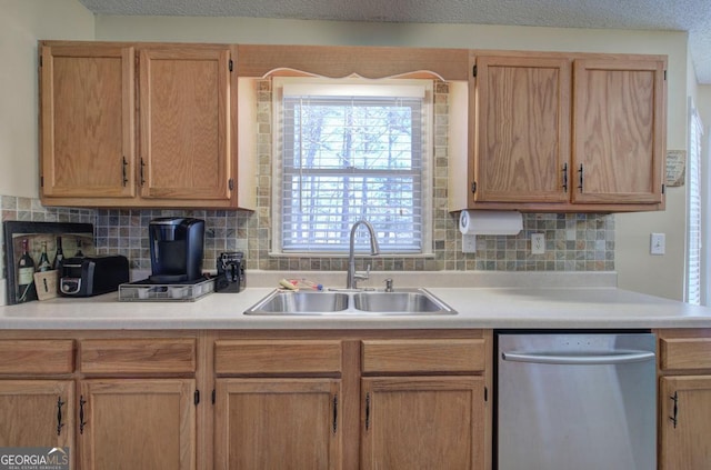 kitchen with tasteful backsplash, sink, light brown cabinetry, and dishwasher