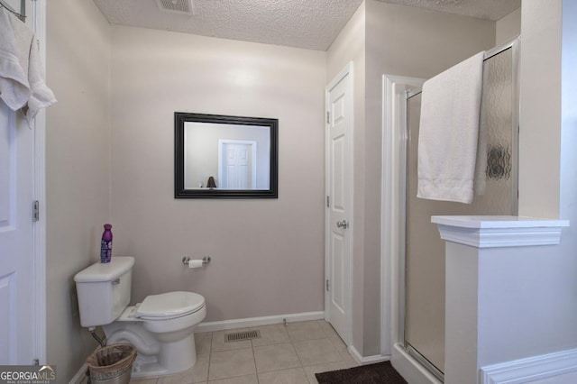 bathroom featuring a shower with shower door, tile patterned floors, a textured ceiling, and toilet