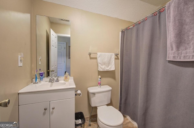 bathroom featuring vanity, walk in shower, a textured ceiling, and toilet