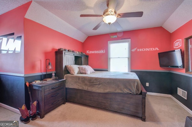 bedroom featuring vaulted ceiling, light carpet, and ceiling fan