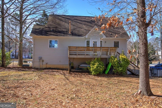 back of property featuring a wooden deck