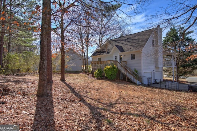 exterior space featuring a wooden deck and a garage