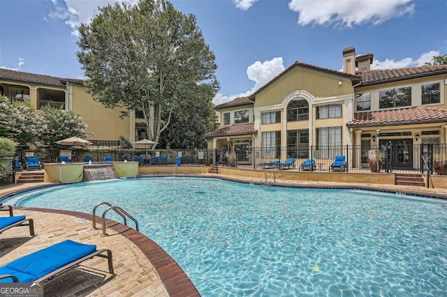 view of pool with pool water feature and a patio area