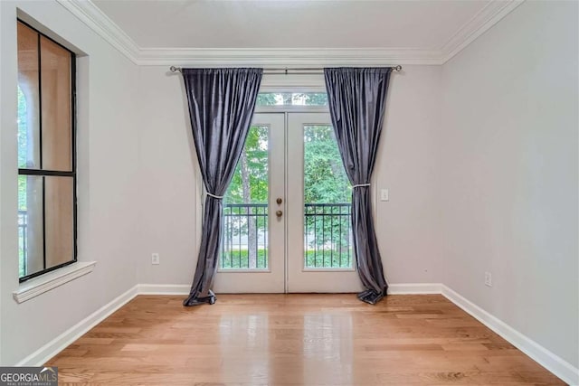 entryway featuring crown molding, light wood-type flooring, and french doors