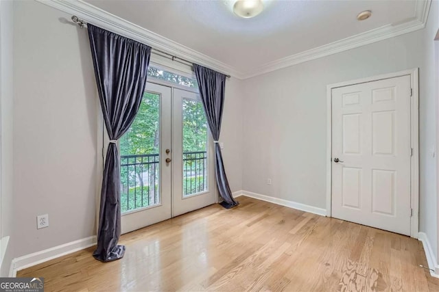 unfurnished room with french doors, ornamental molding, and light hardwood / wood-style flooring