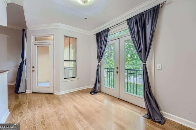 doorway to outside with french doors, ornamental molding, and light wood-type flooring