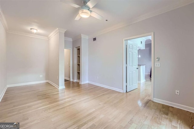 spare room featuring crown molding, ceiling fan, and light wood-type flooring