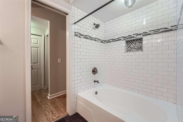 bathroom with tiled shower / bath combo and wood-type flooring