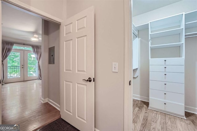 interior space with french doors, electric panel, and light hardwood / wood-style flooring