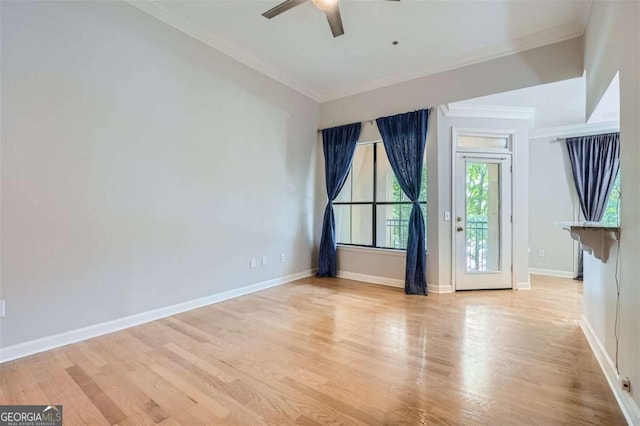 spare room with ceiling fan, ornamental molding, and light hardwood / wood-style floors