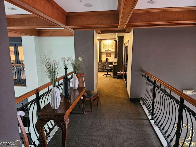 hall with beamed ceiling, carpet, and coffered ceiling