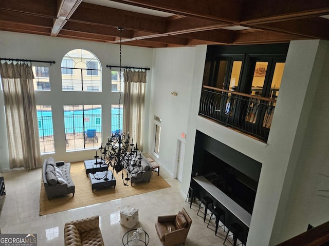 living room with beamed ceiling, a towering ceiling, coffered ceiling, and light tile patterned flooring