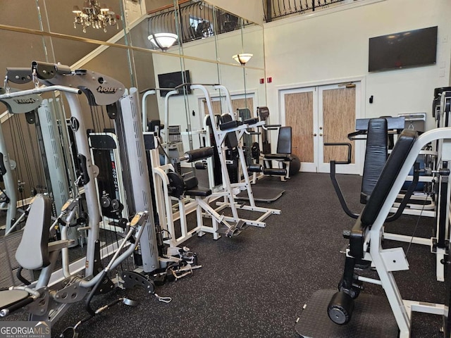 exercise room with a high ceiling and french doors