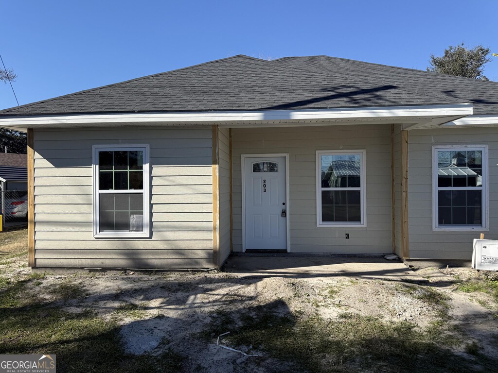 view of front of house with roof with shingles