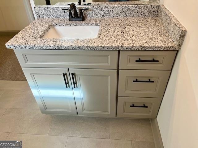 bathroom with tile patterned floors and vanity