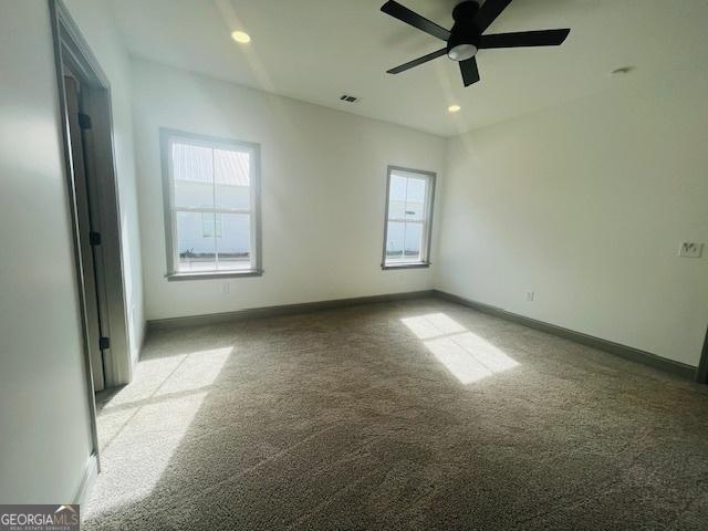 unfurnished room featuring light carpet and ceiling fan