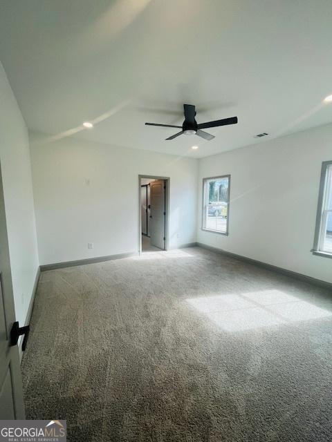 carpeted empty room featuring ceiling fan