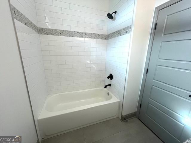 bathroom featuring tile patterned floors and  shower combination