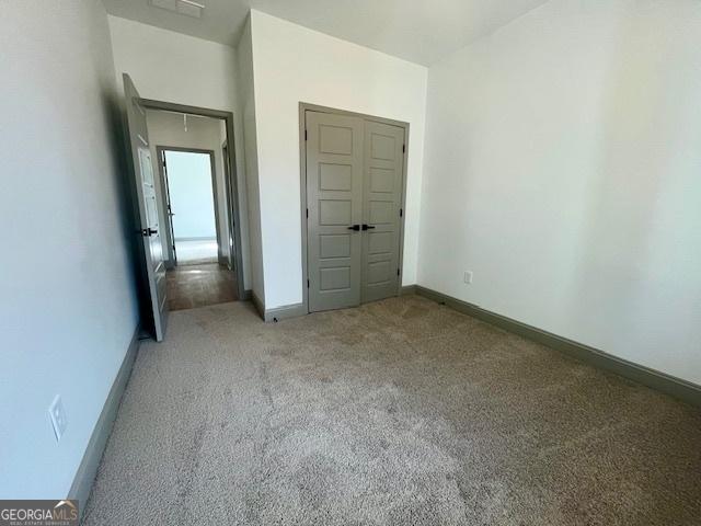 unfurnished bedroom with light colored carpet