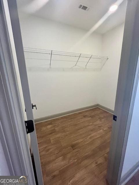 walk in closet featuring dark wood-type flooring