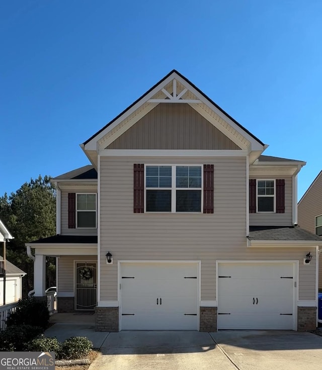 craftsman house featuring a garage, concrete driveway, and stone siding