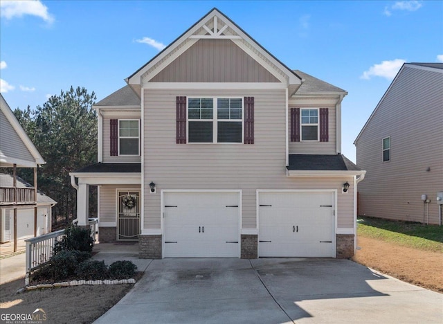 craftsman house featuring a garage, stone siding, and driveway